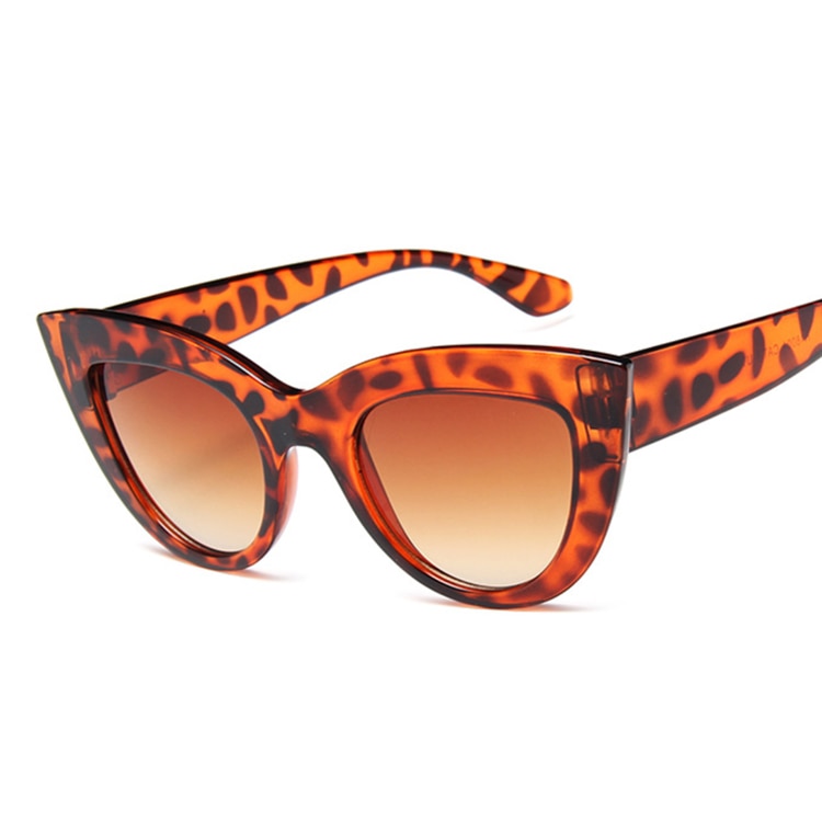 A pair of bold, cat-eye sunglasses with a leopard print frame and tinted lenses.