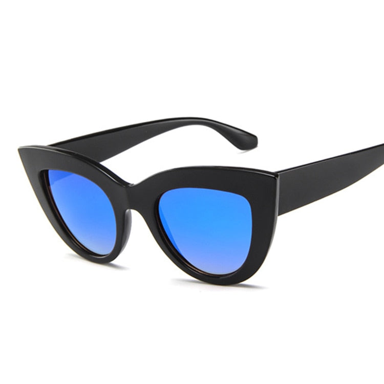 A pair of vintage cat-eye sunglasses with a black frame and blue lenses.